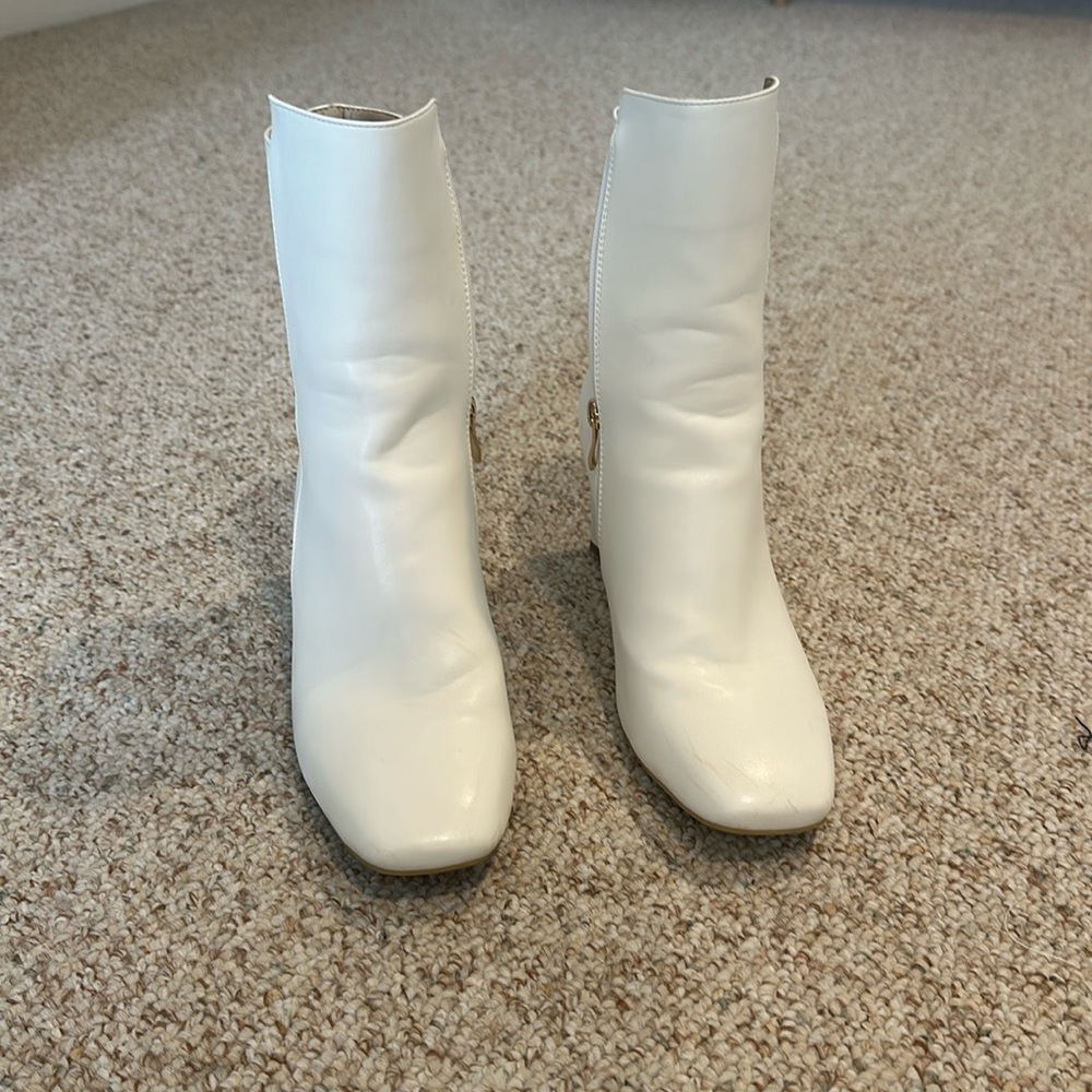White boots with gold hardware